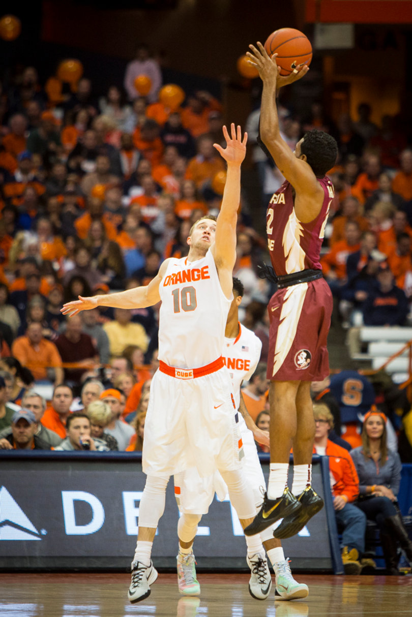 Florida State's Xavier Rathan-Mayes rises for a jumper over Trevor Cooney in the first half. The FSU freshman had two points in the opening half.