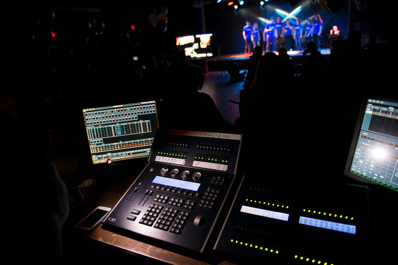 The sound crew at Disabilifunk monitors the audio and visual equipment while a cappella group Oy Cappella performs. 