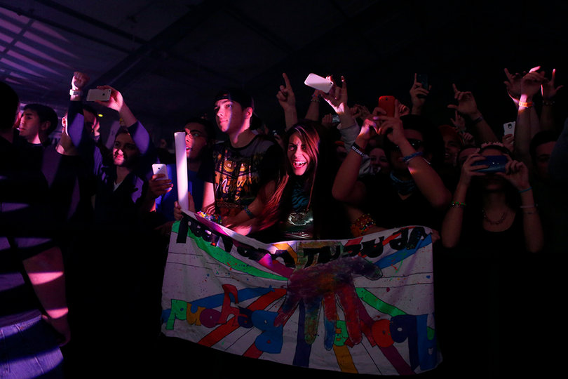 Alyssa from Burlington, N.Y. holds an "Above and Beyond" sign at the concert at the Above and Beyond concert at the F-Shed Wednesday night.  Above and Beyond is an EDM group.