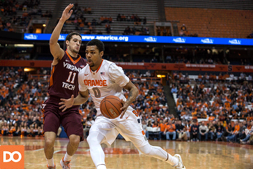 SU forward Michael Gbinije attacks the left lane and doges a pair of Hokies defenders to get to the rim.