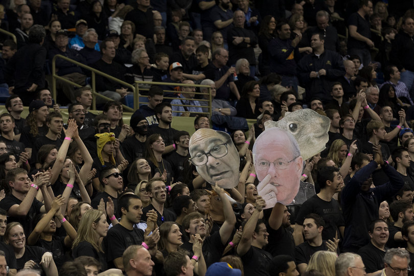 Fans in the "Oakland Zoo" hold up signs mocking SU head coach Jim Boeheim.