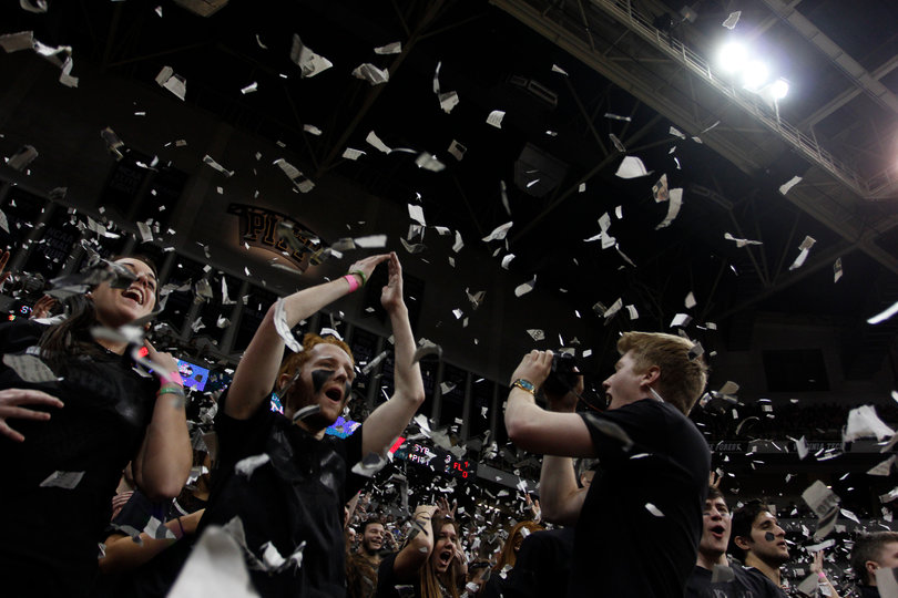 Fans throw shreds of newspaper in the air over the heads of Pittsburgh's cheerleaders.