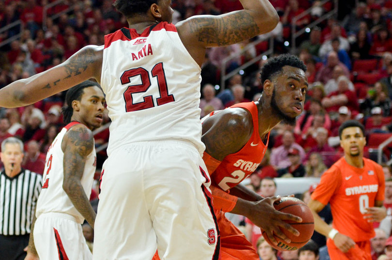 Christmas bodies up N.C. State center BeeJay Anya under the hoop. Christmas finished his career with a 15-point showing on Saturday.