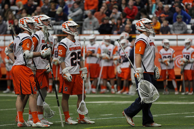 Wardwell and Syracuse defenders look up at the video replay on the scoreboard after being scored on.