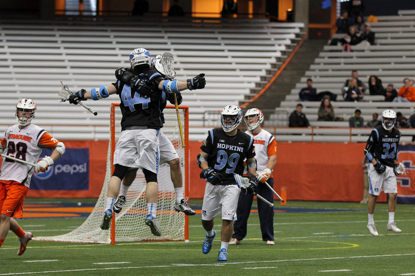 JHU's John Crawley celebrates with a teammate. The Blue Jays went on a 3-0 run to open the game against Syracuse.