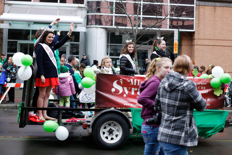 Syracuse University alumna, Alexandra Curtis rides atop a Miss Syracuse float at the St. Patrick’s day Parade. Curtis graduated last spring and was the previous president of the Student Association at SU.