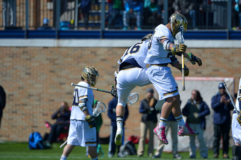 Perkovic leaps high in the air with his teammate after a goal for the Fighting Irish.