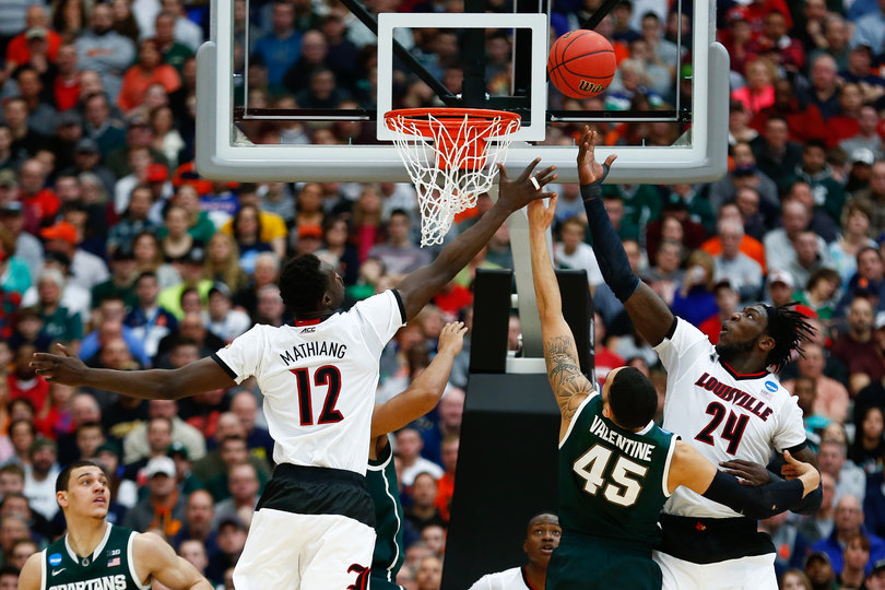 Louisville's defense fights for a rebound in the paint over Michigan State's Valentine.