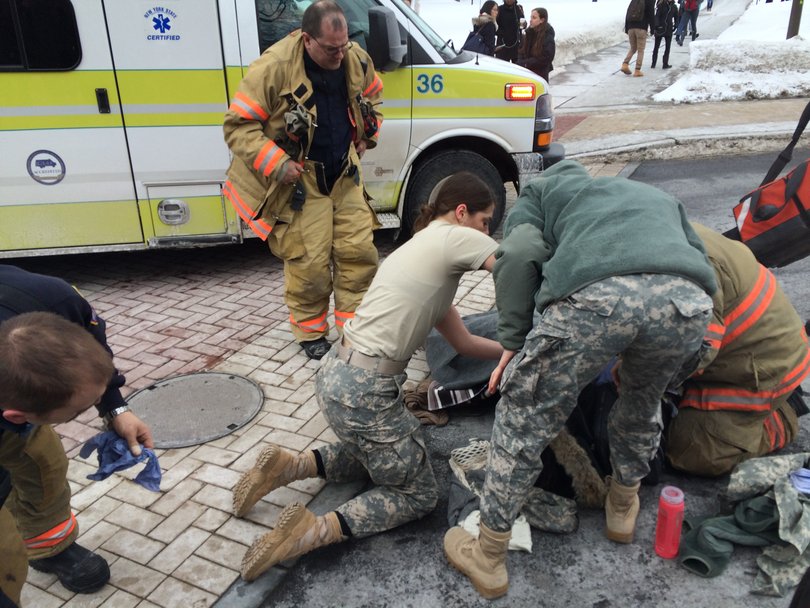 Students assist first responders in tending to a girl who was hit by a Jimmy John's deliveryman on a bike on Thursday afternoon.