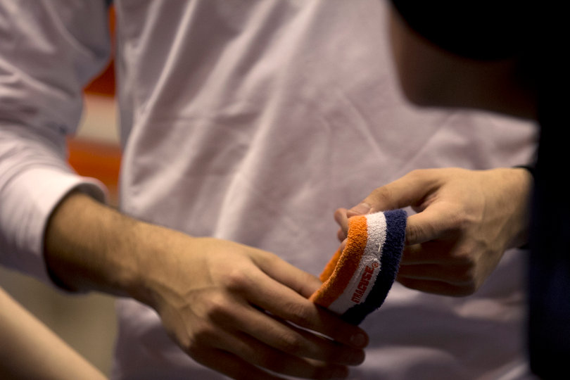 Pregler plays nervously with his Syracuse University head band before his second half performance. He wears the headband for every appearance as Otto the Orange. 