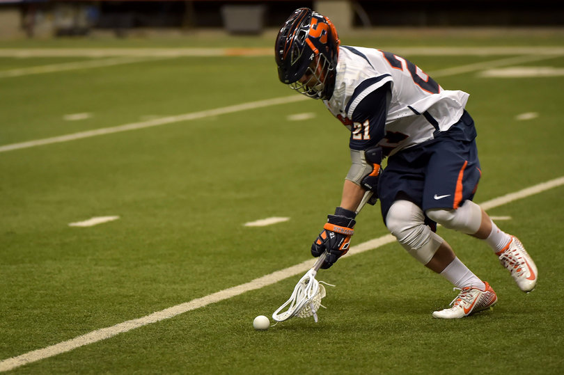 Messina goes to pick up a ground ball. The senior midfielder picked up four ground balls in the match.