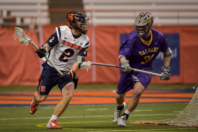 SU attack Kevin Rice runs with the ball as he's guarded by UA's Mike Russell.