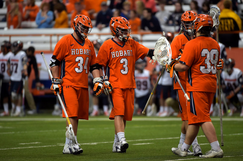 Hobart players gather around their goal. 