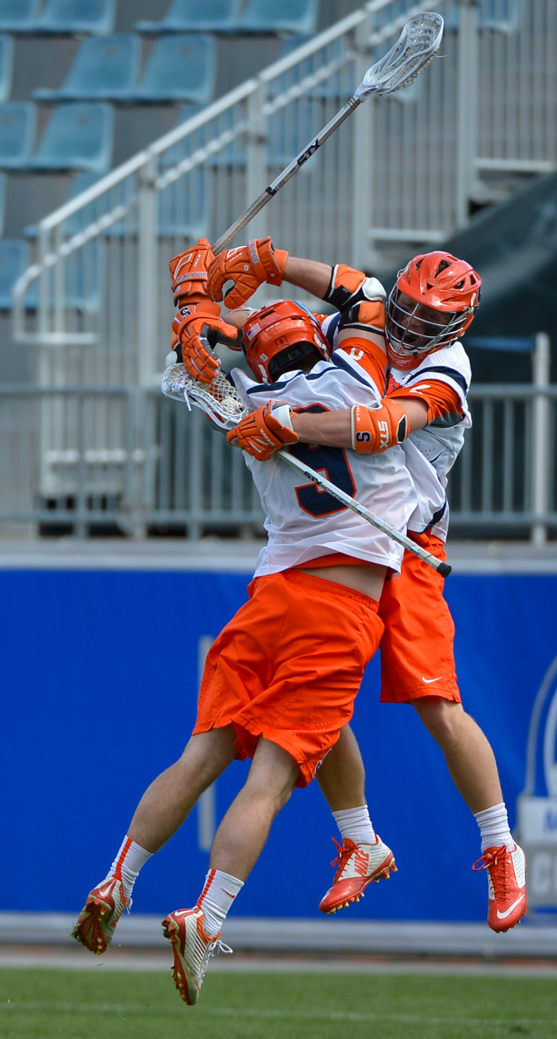 SU midfielder Tim Barber (9) and attack Kevin Rice (2) embrace during the Orange's victory.