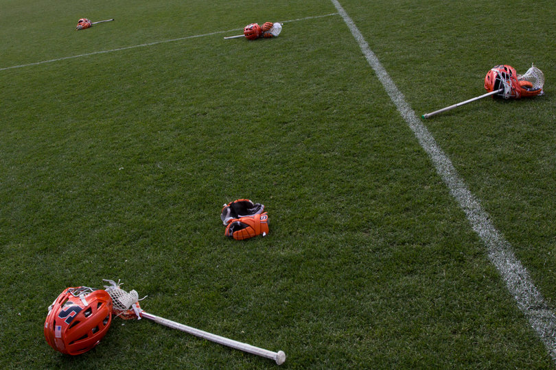 SU helmets, sticks and gloves lie on the PPL Park grass.