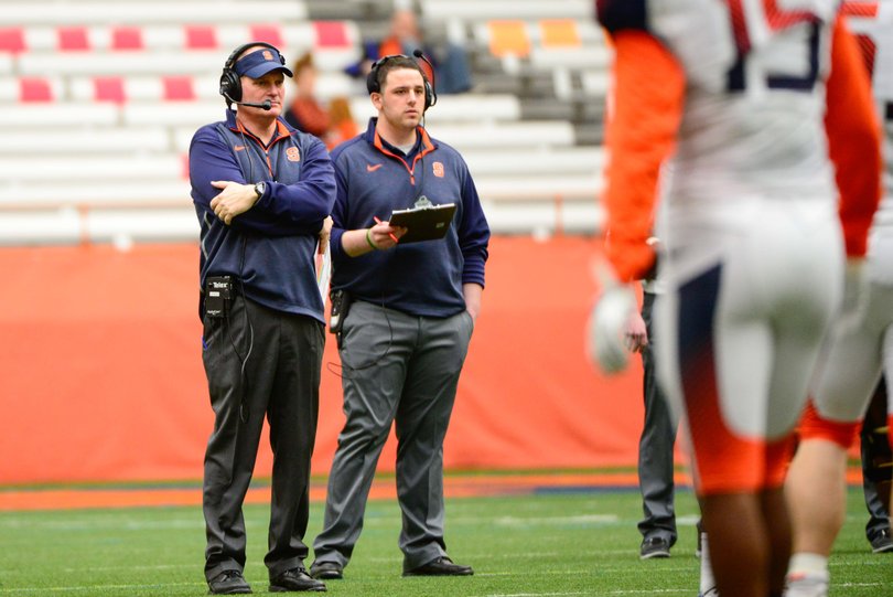 Syracuse head coach Scott Shafer observes his team from the middle of the field.