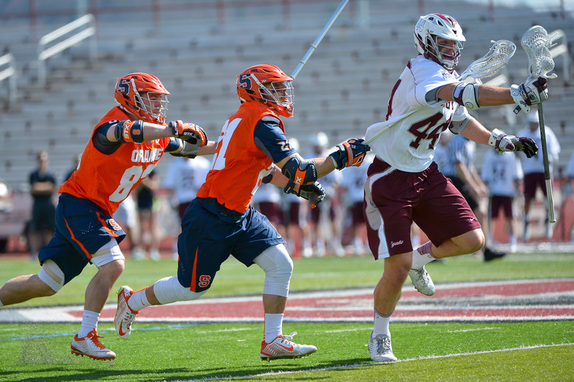 Two Syracuse players try and chase down a Colgate player. 