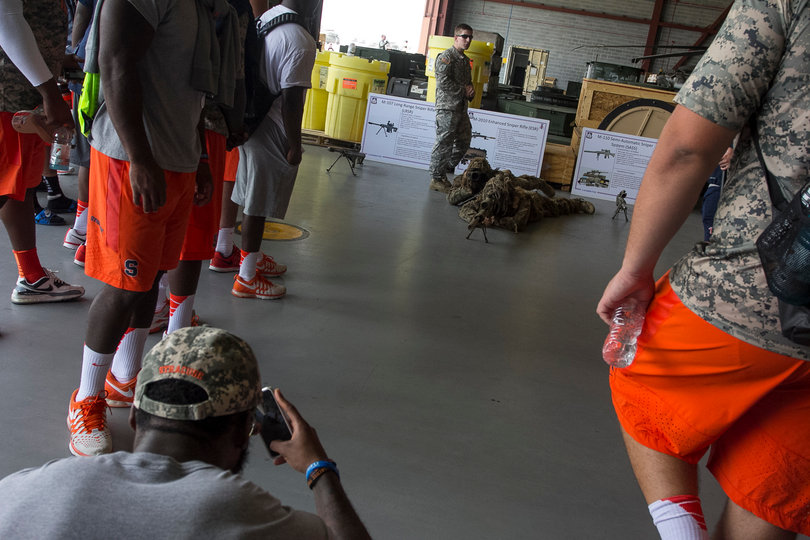 One of the Syracuse players takes a camera phone picture of a gun staring back at him. 
