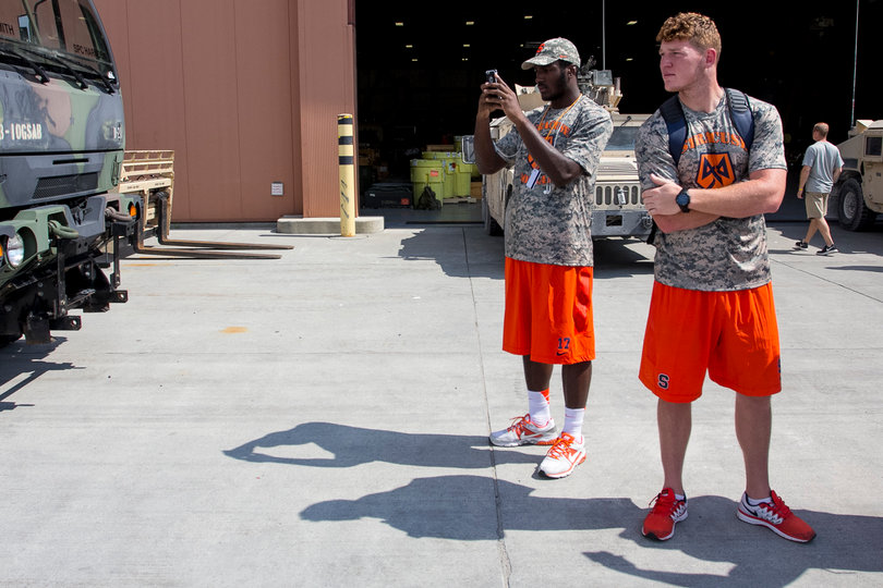 (From left) Jamal Custis and Riley Dixon look on at the airfield at Fort Drum. 