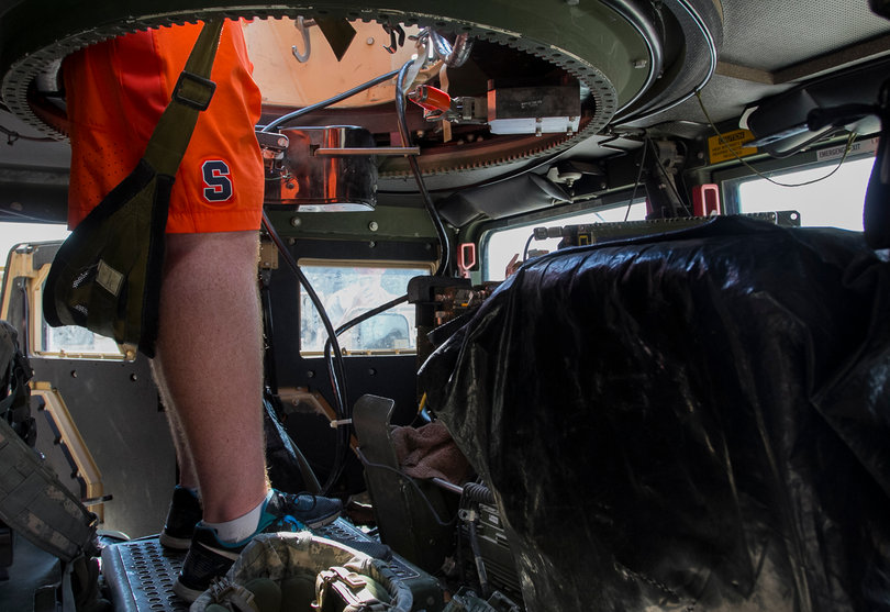 A Syracuse player stands inside the humvee.