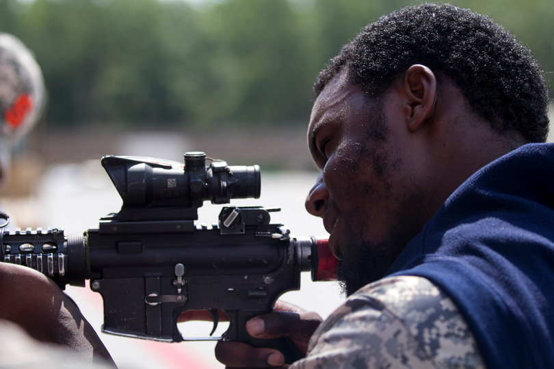 Avant simulates taking aim with a gun. 