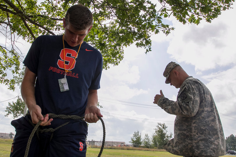 Nathan Hines makes sure his harness rope is secure.