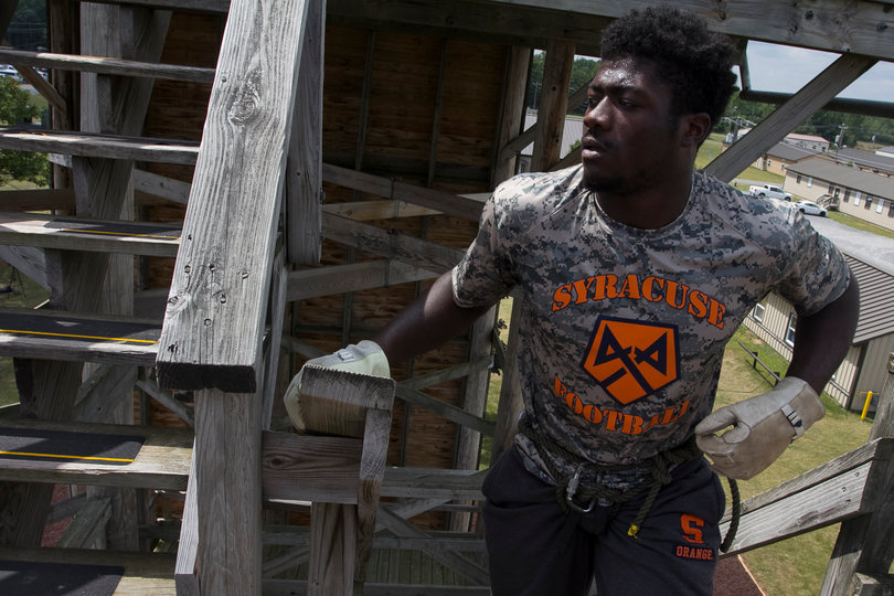 Parris Bennett climbs the stairs to the rappelling platform.