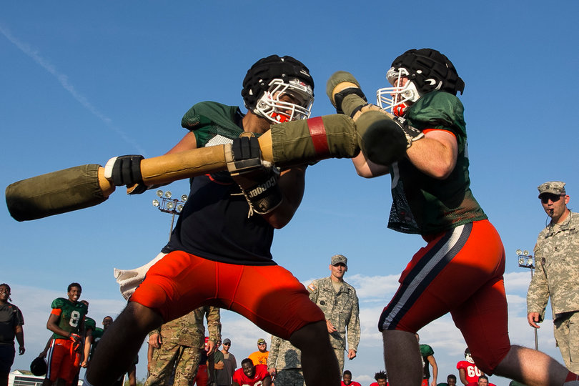 Mitsuuchi and Keller square off as members of the military look on.