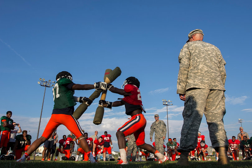 (From left) Tight end Kendall Moore and linebacker Jonathan Thomas lock their pugil sticks against each other's.