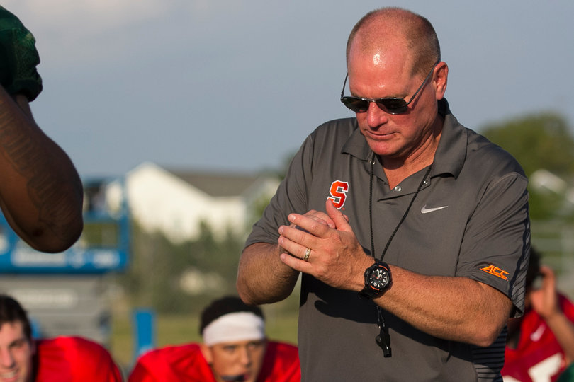 Head coach Scott Shafer looks on as his players attack each other.