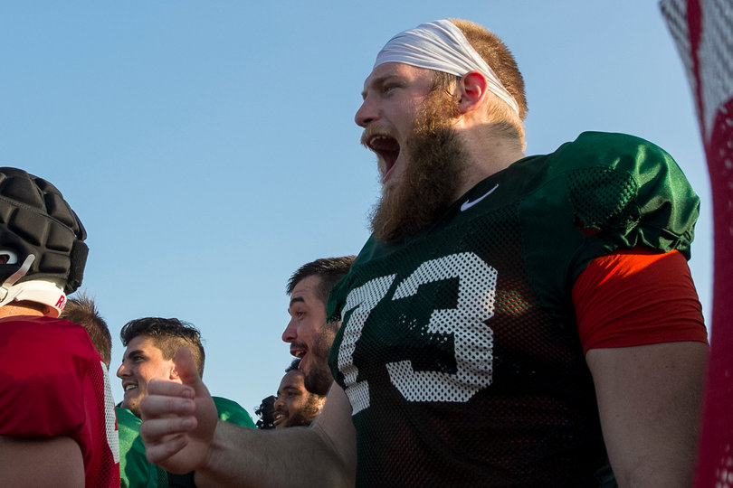 Sophomore offensive tackle Jon Burton yells while watching the action.