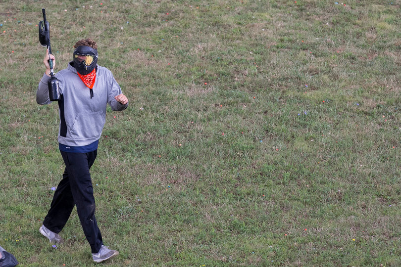 An SU player holds up his arms as he walks across the field.