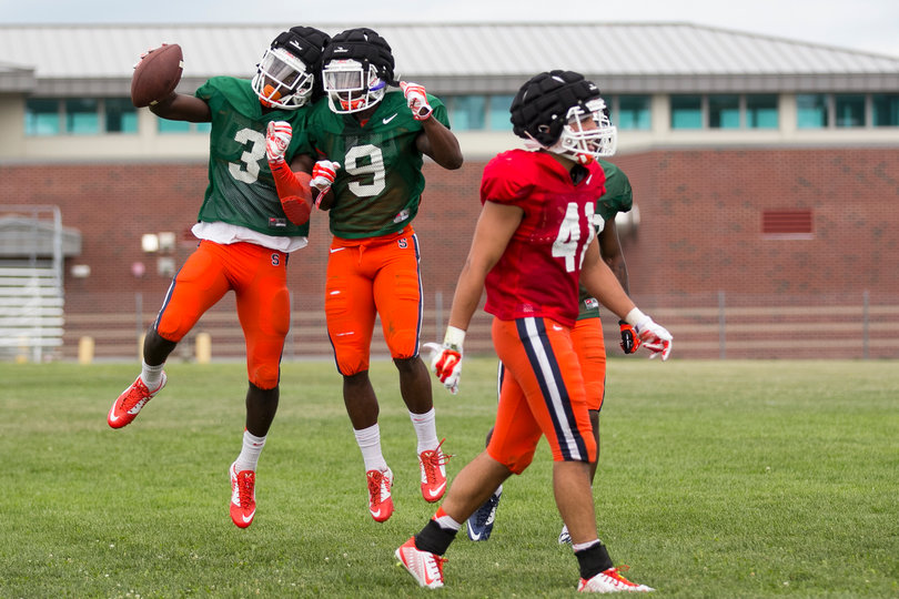 (From left) Philips and Estime side bump after a touchdown as safety Eric Anthony walks away.