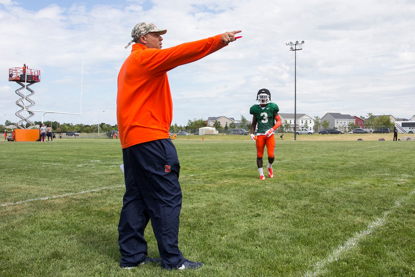 Sophomore hybrid Ervin Philips receives instruction from wide receivers coach Bobby Acosta before fielding a punt.