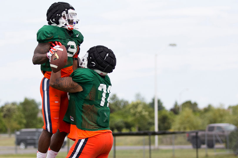 Senior offensive tackle Ivan Foy lifts up junior wide receiver Brisly Estime.