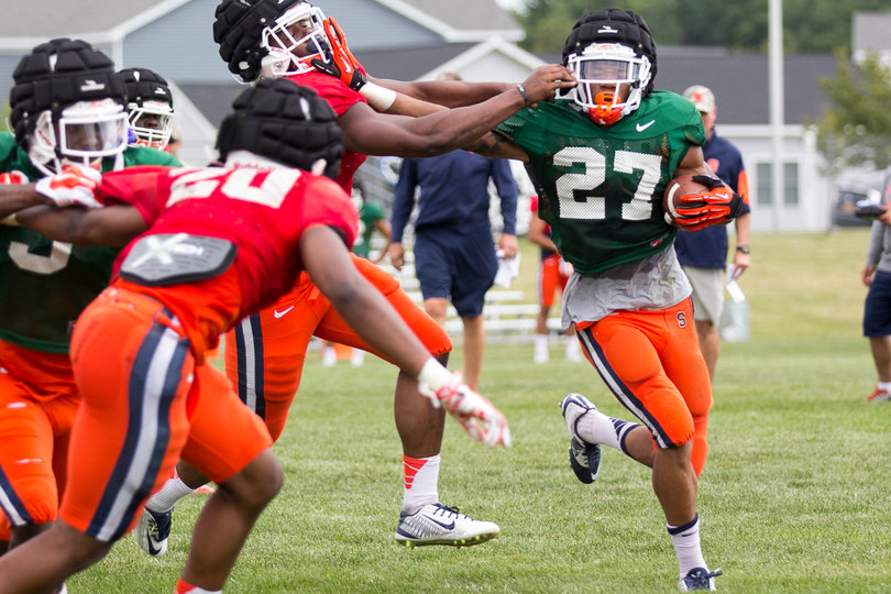 Morris executes a stiff arm while trying to pick up yards downfield.