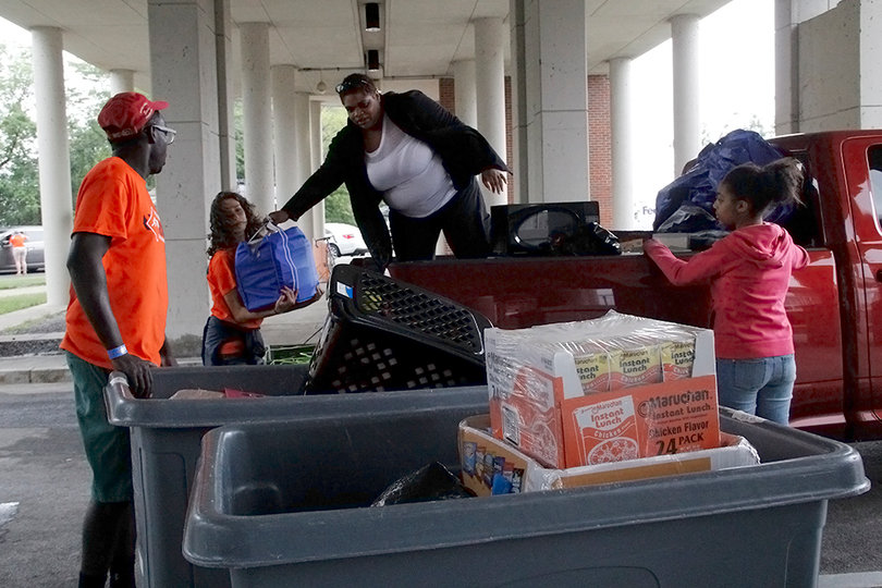 Taylor Henry assists Kerstin Murry with packing her things into a bin to be taken to her dorm room.