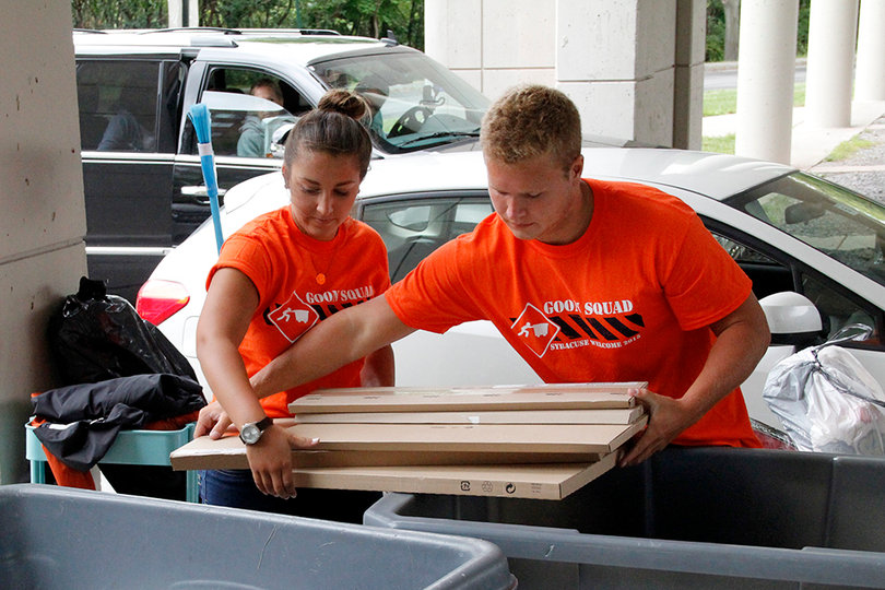 Rachel Viggiano and Dylan Mahan move items into bins to help students move into their new rooms. Goon Squad is made up of student volunteers who help students move their belongings from their cars to their rooms.