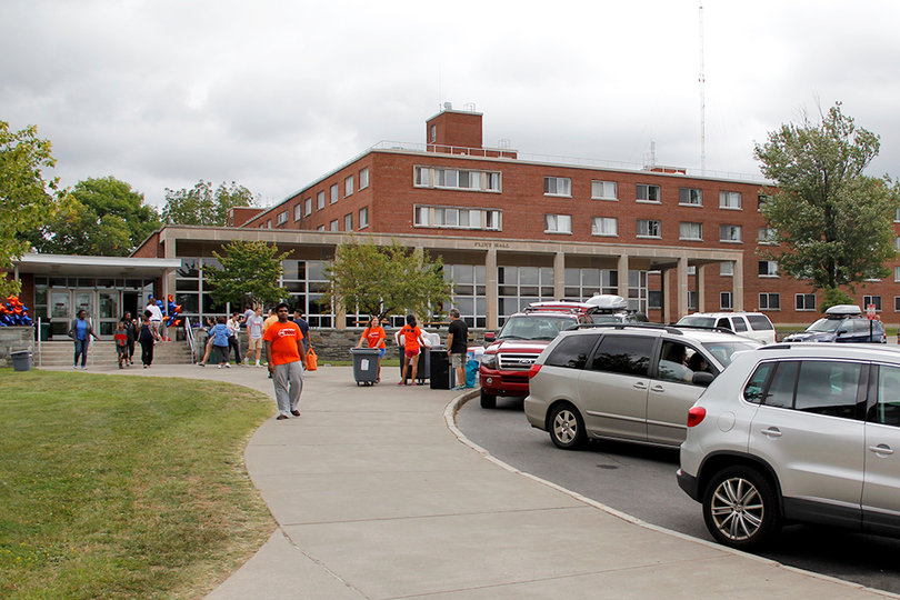 Students and parents gather around the entrance to Flint Hall on move-in day.