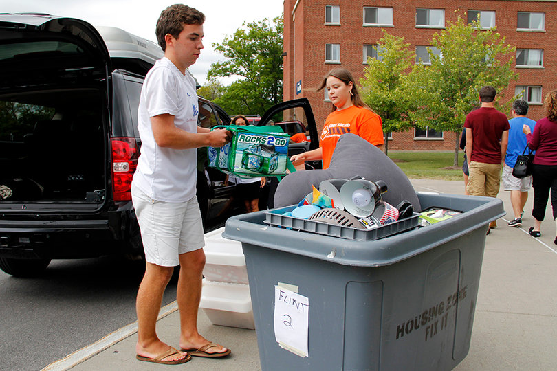 Nick Kelly, an incoming freshman, loads his items into a bin to move to his new room. 