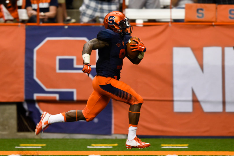 Wide receiver Brisly Estime runs down the sideline holding the football. 