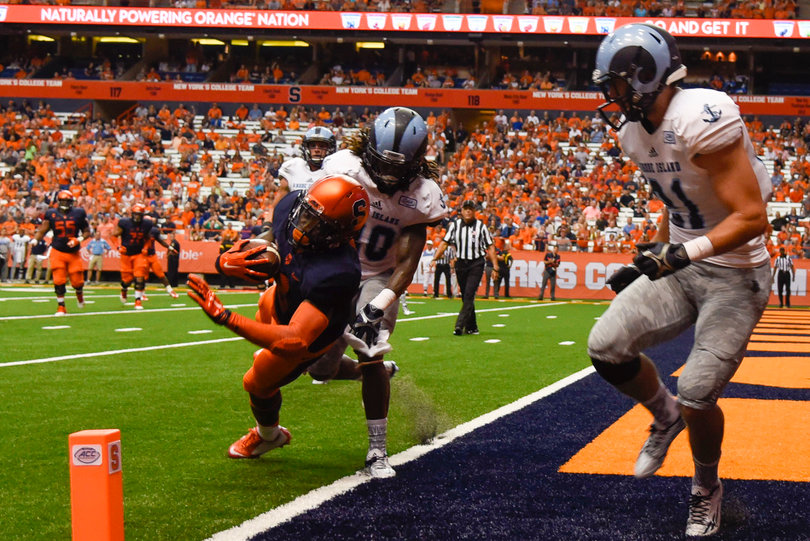 Sophomore hybrid Ervin Philips falls into the front corner of the end zone between two Rams defenders.