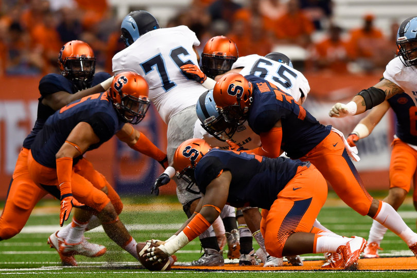 Three Orange defenders converge on a loose ball dropped by Rhode Island.