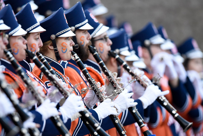 Members of the marching band play for fans before the game.