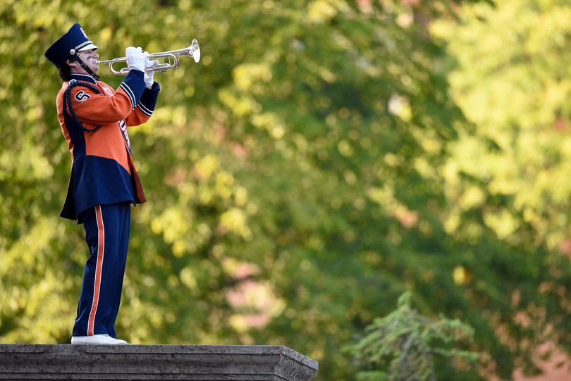 A member of the marching band plays for fans outside of Hendricks Chapel.