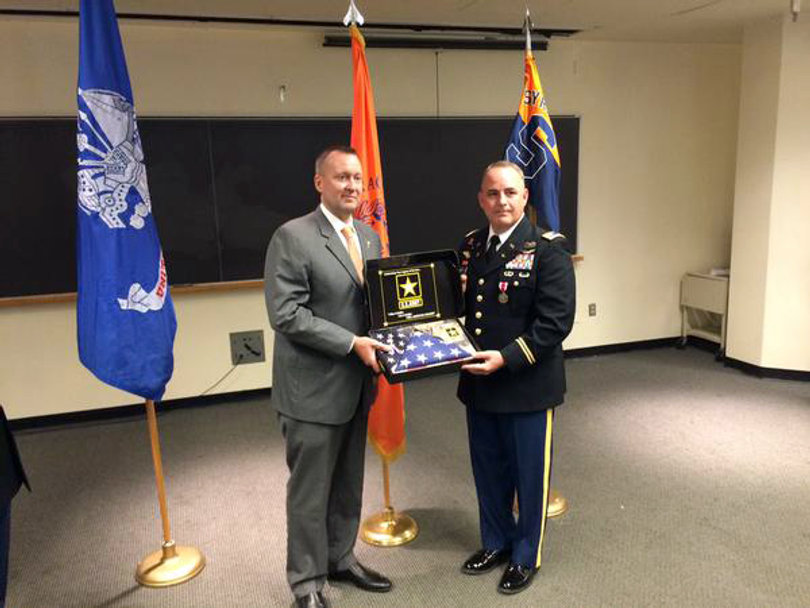 (from left) Mike Haynie and Lt. Col. Michael Bianchi participate in a ceremony in the Hall of Languages for Army ROTC leadership change.