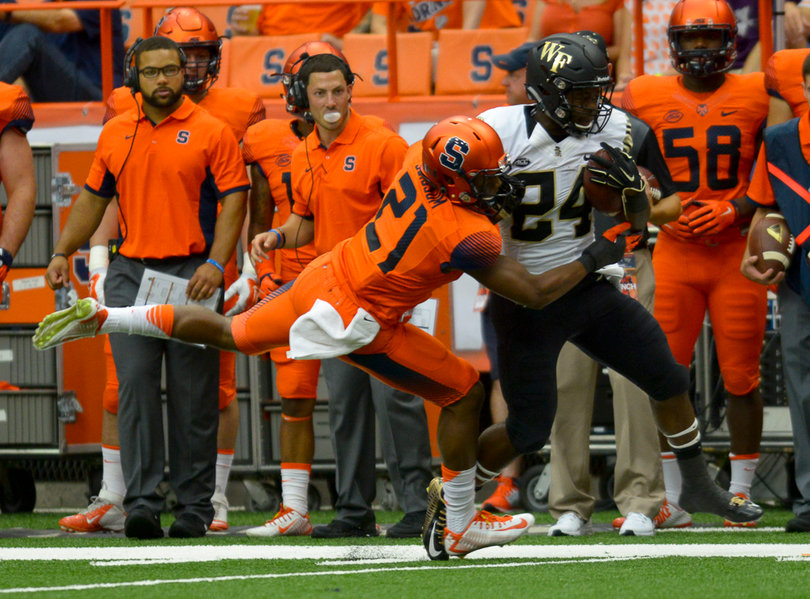 Scissum tries to tackle Demon Deacons running back Tyler Bell.