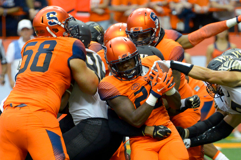 Freshman running back Jordan Fredericks tries to run past a mob of Syracuse and Wake Forest linemen.