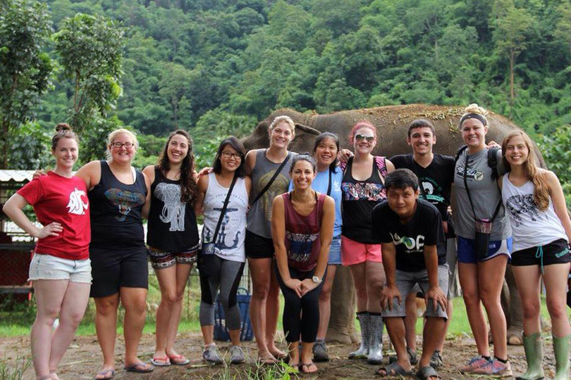 Yvonne Lim and other members of Loop Abroad's College Veterinary Service program pose near an elephant at Elephant Nature Park in Thailand.
