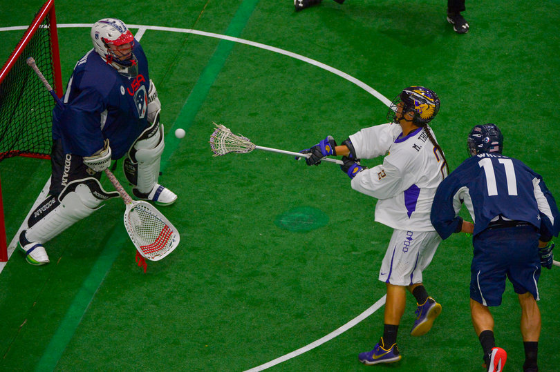 Miles Thompson, Lyle's brother, shoots from just outside the crease while absorbing pressure from Joel White.